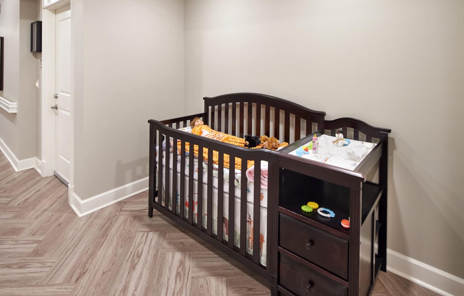 infant crib with changing table and baby toys