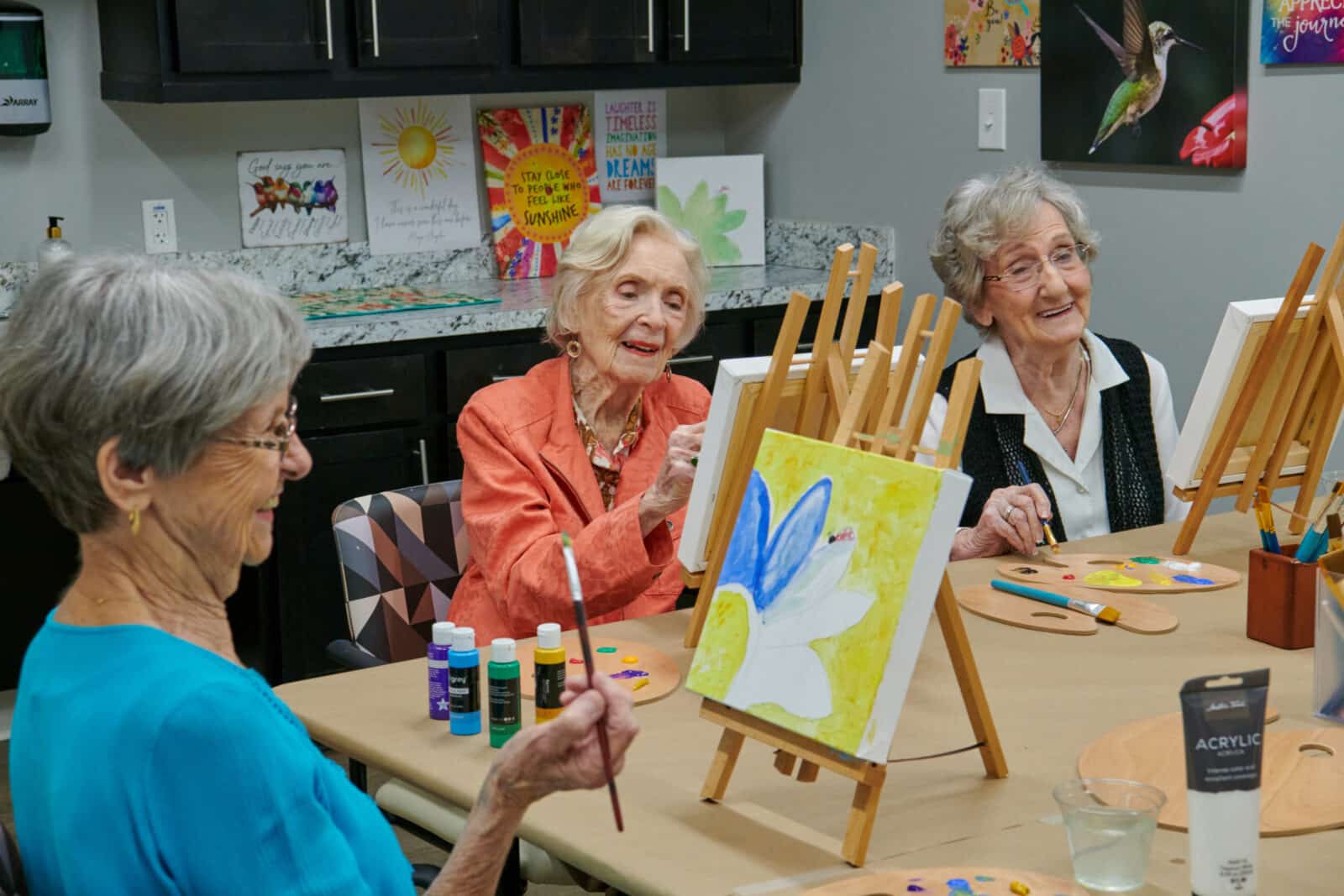 friends enjoying time together laughing and painting