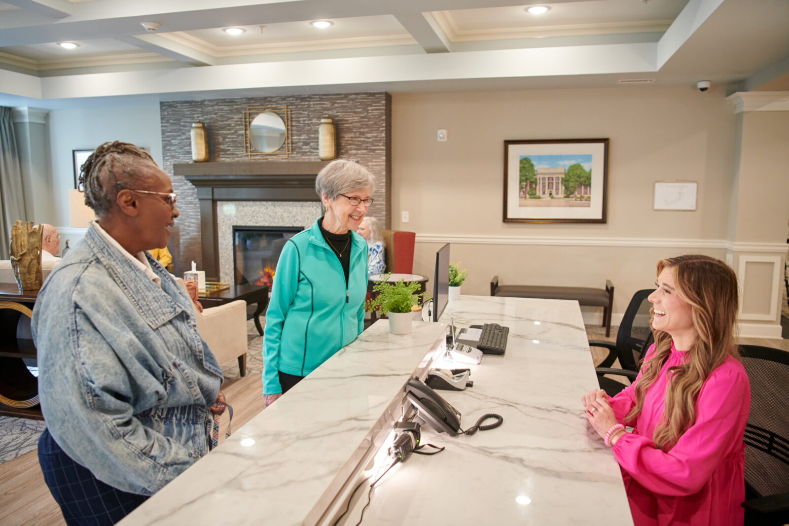 two seniors talking with the receptionist at The Crossings at North River